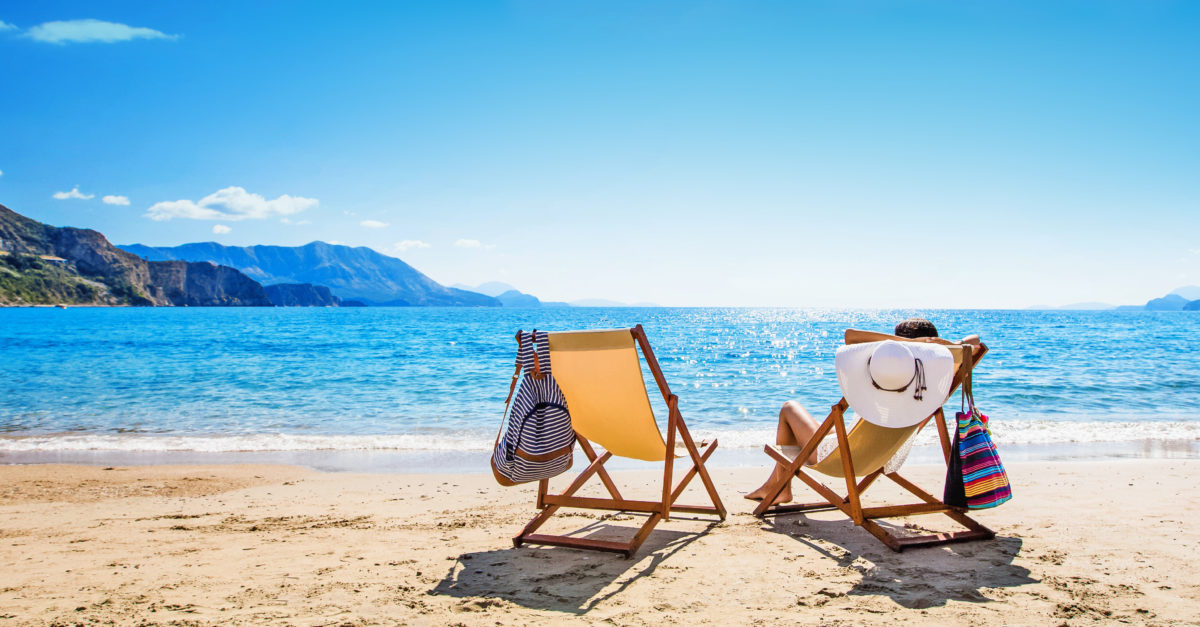 Woman enjoying sunbathing at beach. Summer vacation